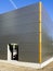 Gray sandwich panels facade of a new metal construction thermally insulated industrial building