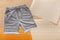 Gray shorts pants for man sport. Basic casual clothing sports gray male shorts On beige background. Flat lay with copy