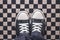 Gray Sneakers on Checkered Pattern Pavement, Top View