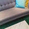 Gray sofa with blue and yellow cushions