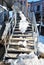 Gray stairs covered with white snow, city landscape