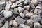 Gray stone closeup. Stone texture. Scattered gray cobblestones. Stone path background above. Gravel.  Stone wall background. Many