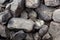 Gray stone closeup. Stone texture. Scattered gray cobblestones. Stone path background above. Gravel.  Stone wall background. Many