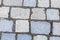 Gray stone pattern row of cobblestones dark cement stripes hard weathered urban style