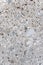 Gray stone slab with cut surface and mixture of pebbles and concrete