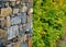 Gray stone wall with solid wood bench folded without cement and concrete. stone quartzite durable retaining wall, garden park. tri