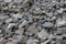 Gray stones cobblestone rough form, gravel building material, garden decor. Background texture close-up