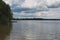 Gray storm clouds over the forest and lake. Pisochne ozero. Volyn region. Ukraine