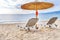 Gray straw umbrella on beautiful beach and ocean background