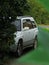 Gray Subaru Forester in green grass and bushes. Silver.