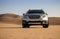 Gray Subaru in the sand of the Namib desert at a bright sky.