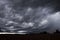 GRAY SWIRLING STORM CLOUDS ON HORIZON