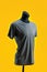 A gray t-shirt on a mannequin on a yellow background