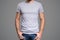 Gray t-shirt on a young man template. Gray background.