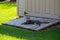 Gray tabby cat reclining on a garden shed entry ramp