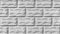 The gray texture of a concrete wall with cracks, imitation of stone blocks or bricks, architecture abstract background