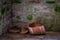 The gray und old stone wall and broken clay pot