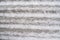 Gray undulating background. It`s a slightly snow-covered slate sheet. Horizontal stripes