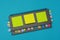 Gray weekly planner with bookmarks and yellow stickers on a light blue background. Business planning and personal growth concept.