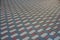 Gray, white and red patterned paving tiles on the ground of street, perspective view.