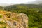 Gray wild rocks and wild green forest. View from above. Landscape