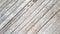 Gray wooden background with diagonal lines. Board background with copy space. Wooden old boards with cracked gray paint on the