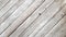 Gray wooden background with diagonal lines. Board background with copy space. Wooden old boards with cracked gray paint on the
