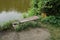 A gray wooden bench stands on an old bridge