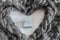 Gray woolen braid in a heart shape with Little gift box in the center