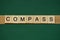 Gray word compass made of wooden square letters
