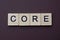 Gray word core from small wooden letters