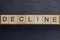 Gray word decline from small wooden letters