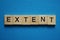 Gray word extent in small square wooden letters