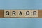 gray word grace in small square wooden letters