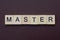 gray word master made of wooden square letters