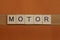 Gray word motor made of wooden square letters