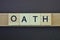 Gray word oath made of wooden square letters