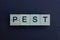 Gray word pest made of wooden square letters