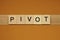 Gray word pivot made of wooden square letters