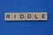 Gray word riddle from small wooden letters