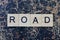 gray word road from wooden letters in black font