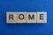 Gray word rome from small wooden letters