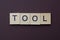 Gray word tool from small wooden letters