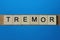 Gray word tremor in small square wooden letters