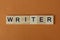 Gray word writer made of wooden square letters