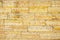 Gray and yellow cinder block wall background,