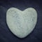 Gray zen heart shaped rock on a tile