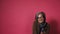 Graying pretty woman take phone down smiles. Smart mature lady in eyeglasses and brown jacket on pink background. Text