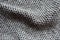 Grayish brown woolen fabric with diamond pattern in soft folds