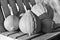 Grayscale closeup of pumpkins on a wooden bench